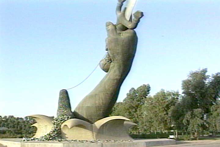 Hands with Swords form a victory arch. Note Helmets of the fallen Enemy.